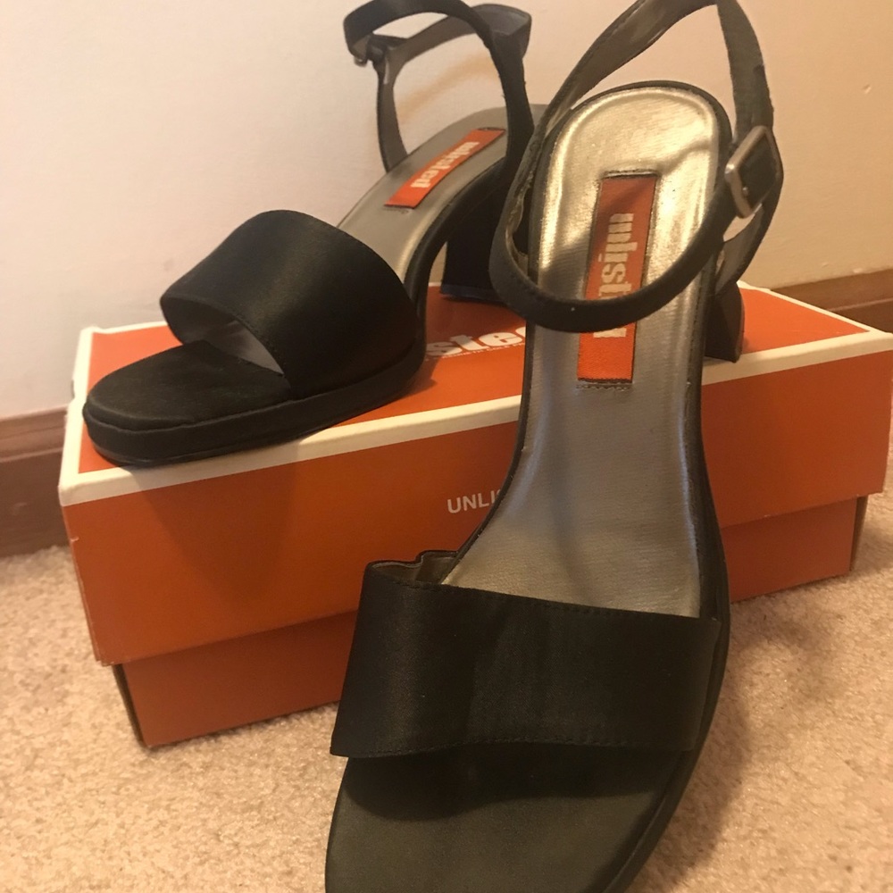 Unlisted high-heeled black dress shoes.